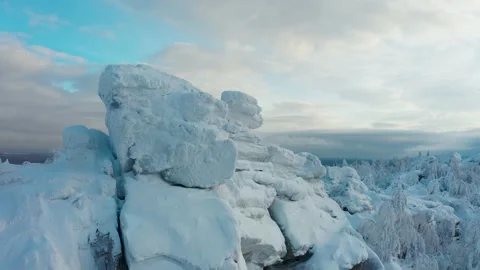 Cinematic aerial view of the endless snow forest from behind the cliff Stock Footage 146477183
