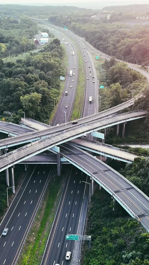 Cinematic aerial view of a highway interchange with light traffic... Vídeo Stock 344332611