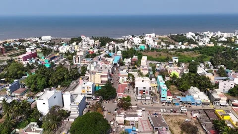 Cinematic aerial view of Kovalam featuring the Kovalam Bus Stand, bustling town Stock Footage 340320643