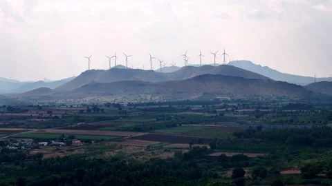 Cinematic aerial view of a multilane highway cutting across expansive patchwork Stock-Footage 335886911