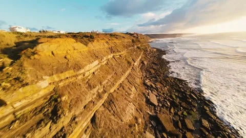 Cinematic aerial view of ocean waves at golden hour Stock Footage 340913941