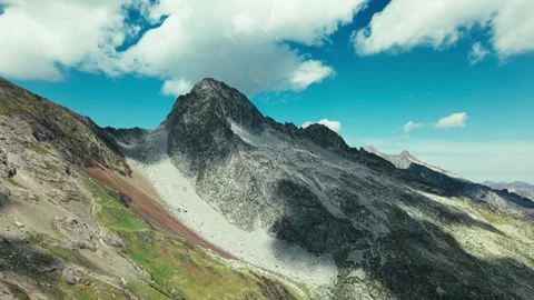 Cinematic aerial view of sharp rocky mountain Stockbeeldmateriaal 344651930