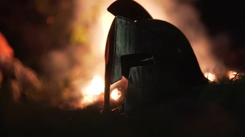 Cinematic Ancient Warrior Helmet In Aftermath Of Battle In Front Of Fire Stock Footage 109340680
