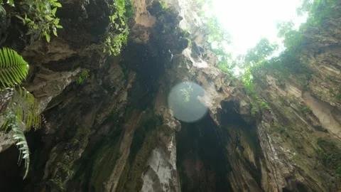 Cinematic Approach to Limestone Cave Wall with Water Dripping and Light Above Stock Footage 335263377