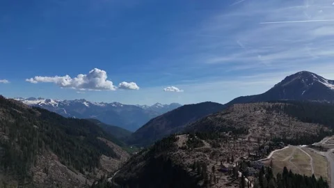 Cinematic Arc Flight Over Mountain Crest Showing Ski Trails and Valley D Stock Footage 339310844