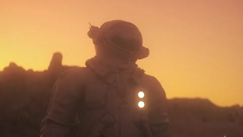 Cinematic Astronaut Standing on Alien Desert Planet at Golden Sunset Stock Footage 338410641