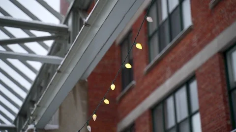 Cinematic b-roll footage of string lights hang during winter season. Stock Footage 102614534