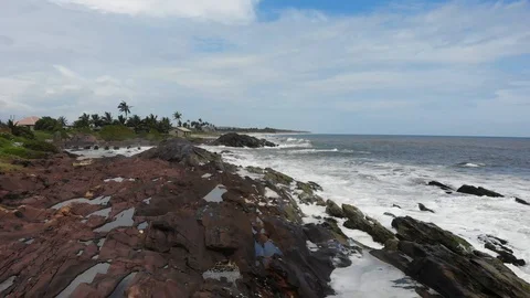 Cinematic Back Pull through Rocks in the Ocean Stock Footage 117696612