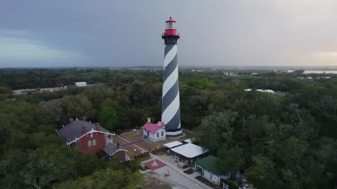 Cinematic bird's-eye view of the St. Augustine Lighthouse at sunset, capturing Stock Footage 332811658