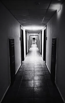 Cinematic Black and White Long Hallway Perspective with Doors Stock Photos