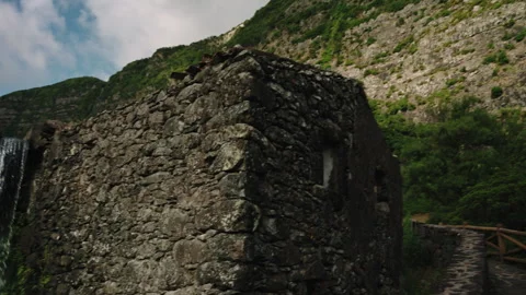 Cinematic Camera Motion From an Ancient Stone Watermill Ruin to a Majestic Tall Video stock 335006393