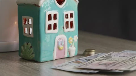 Cinematic camera movement around house model and cash savings Stock Footage 332723714