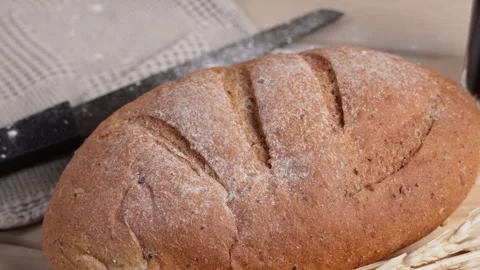 Cinematic camera movement over fresh artisan bread with wheat and baking tools Stock Footage 342485240