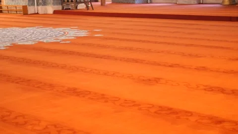 Cinematic camera movement over traditional orange mosque carpet with intric.. Stock Footage 333155994