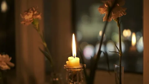 Cinematic, candle, window, flame, carnation flowers. vintage style Stock Footage 296773504