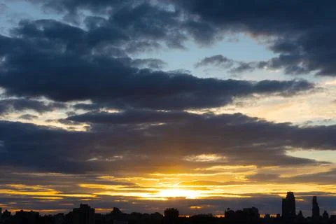 Cinematic cityscape at sunset with dramatic clouds Stock Photos