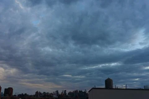 Cinematic cityscape at sunset with dramatic clouds Stock Photos