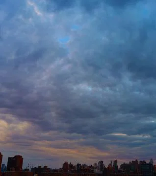 Cinematic cityscape at sunset with dramatic clouds Stock Photos