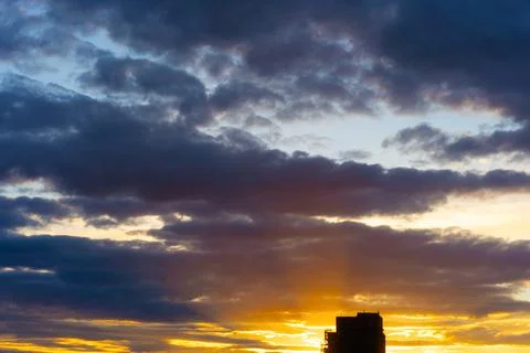 Cinematic cityscape at sunset with dramatic clouds Stock Photos
