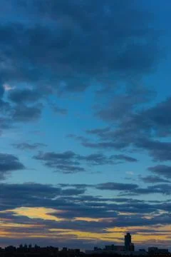 Cinematic cityscape at sunset with dramatic clouds Stock Photos
