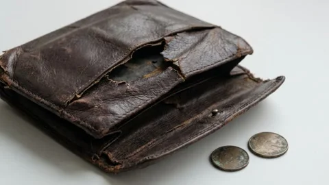A cinematic close-up of a battered, empty brown leather purse 스톡 동영상 333777126