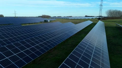 Cinematic close flying pass solar panels, renewable power production net zero UK Stock Footage 324857325