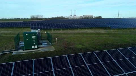 Cinematic close flying pass solar panels, renewable power production net zero UK Stock Footage 324857336