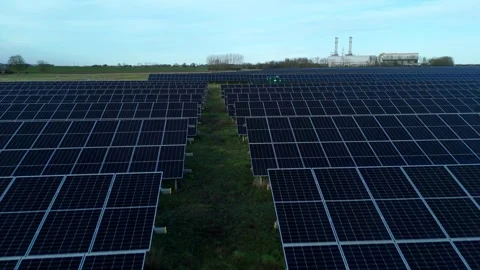 Cinematic close flying pass solar panels, renewable power production net zero UK Stock Footage 324857353