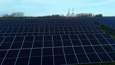 Cinematic close flying pass solar panels, renewable power production net zero UK Stock Footage 324857361