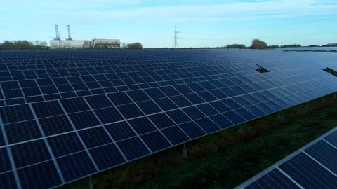 Cinematic close flying pass solar panels, renewable power production net zero UK Stock Footage 324857362
