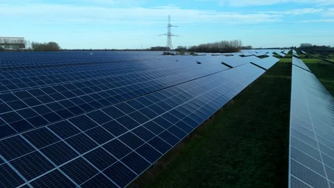 Cinematic close flying pass solar panels, renewable power production net zero UK Stock Footage 324857385