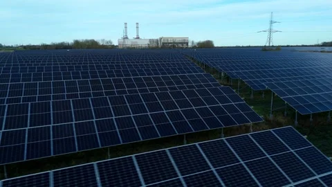 Cinematic close flying pass solar panels, renewable power production net zero UK Stock Footage 324857397