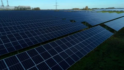 Cinematic close flying pass solar panels, renewable power production net zero UK Stock Footage 324857457