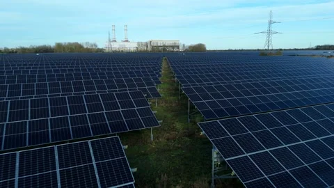 Cinematic close flying pass solar panels, renewable power production net zero UK Stock Footage 324857461