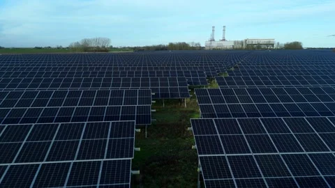 Cinematic close flying pass solar panels, renewable power production net zero UK Stock Footage 324857467