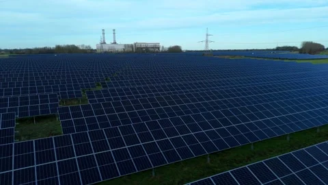 Cinematic close flying pass solar panels, renewable power production net zero UK Stock Footage 324857484