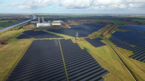 Cinematic close flying pass solar panels, renewable power production net zero UK Stock Footage 328293083