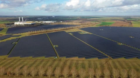 Cinematic close flying pass solar panels, renewable power production net zero UK Stock Footage 328293093