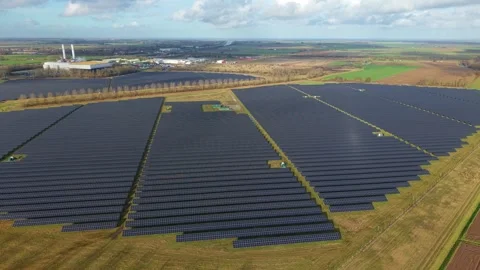 Cinematic close flying pass solar panels, renewable power production net zero UK Stock Footage 328293102