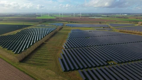 Cinematic close flying pass solar panels, renewable power production net zero UK Stock Footage 328293115