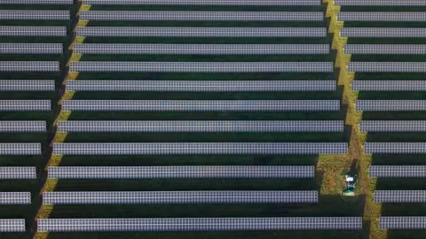 Cinematic close flying pass solar panels, renewable power production net zero UK Stock Footage 328293123