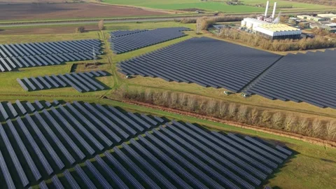 Cinematic close flying pass solar panels, renewable power production net zero UK Stock Footage 328293132