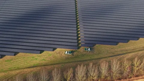 Cinematic close flying pass solar panels, renewable power production net zero UK Stock Footage 328293134