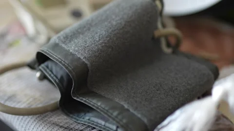 Cinematic close-up of folded felt bag on wooden table Stock Footage 330943045