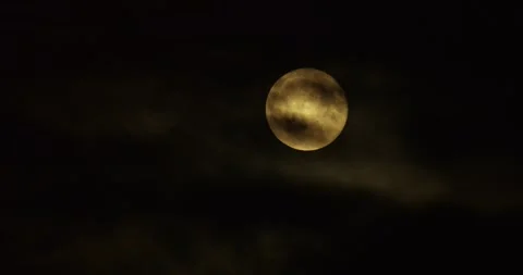 Cinematic close up full moon thick black clouds flowing across sky dramatic Video stock 320896246