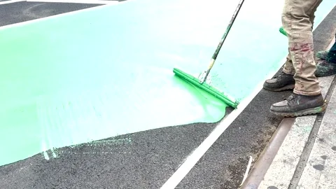 Cinematic Close-Up of Green Paint Roller on Court Stock Footage 346477011