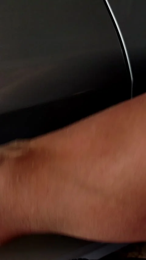 Cinematic close-up of a hand wiping a dark car surface Stock Footage 334129267