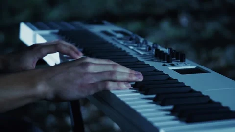 Cinematic Close-Up of Hands Playing Electronic Keyboard in Dark Environment Stock Footage 284482758