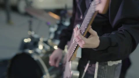 Cinematic close-up of hands playing a white electric guitar Stock Footage 335075926