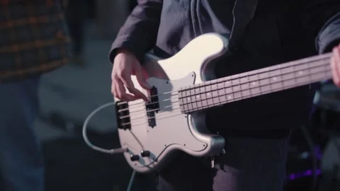Cinematic close-up of hands playing a white electric guitar Video stock 335076009
